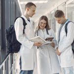 Medical students at the hall. People in a white uniform.