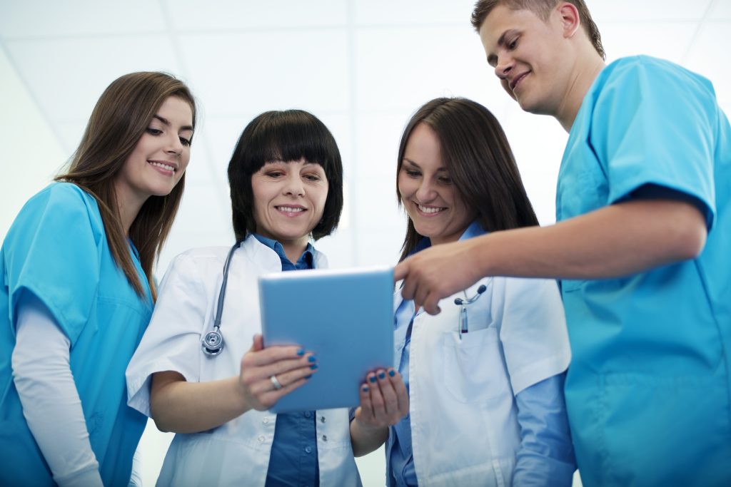 Medical team checking results on digital tablet