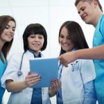 Medical team checking results on digital tablet